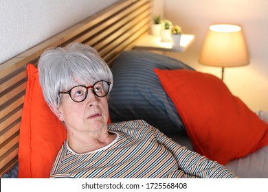 Bored Senior Woman Lying In Bed
