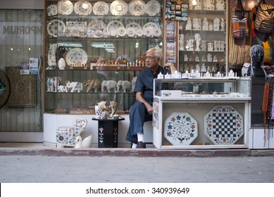 Bored Shopkeeper On Side Of Street - NEW DELHI - INDIA; MAY 16 2015