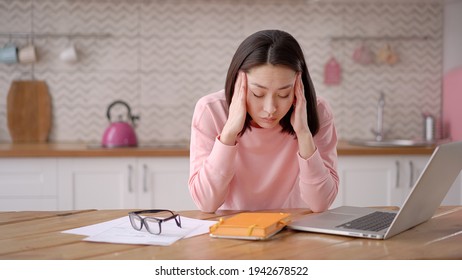 Bored sleepy asian lady sitting at desk with laptop, holding head, resting on hand, sleeping at workplace, tired young female feeling drowsy, lazy and unmotivated student, boring job, lack of sleep