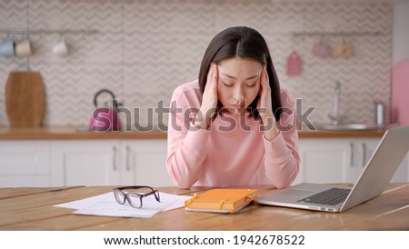 Bored sleepy asian lady sitting at desk with laptop, holding head, resting on hand, sleeping at workplace, tired young female feeling drowsy, lazy and unmotivated student, boring job, lack of sleep