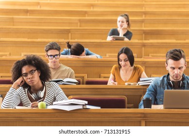 Bored students listening to lecturer at university