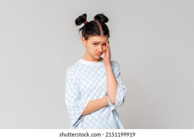 Bored Teen Girl Looking With Sad, Gloomy And Unamused Face At Camera, Standing Upset And Moody In Trendy T Shirt Over Light Grey Background