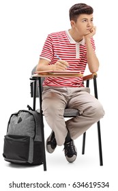 Bored Teenage Student Sitting In A School Chair Isolated On White Background