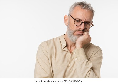 Bored tired exhausted sad caucasian mature middle-aged man teacher freelancer wearing glasses wants to sleep, feeling negative emotions, depression isolated in white background - Shutterstock ID 2175085617