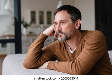 Bored tired sad mature middle-aged man depressed lonely having no visitors of his children. Divorce , bachelor , health problems concept. Lockdown, unemployment, needless man on social distance