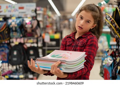 A Bored And Tired School Girl Buying A Notebook In The Store Back To School Bad Emotion	