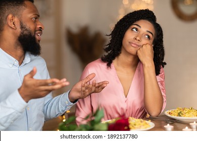 Bored Unhappy Black Girlfriend Listening To African American Boyfriend In Cafe, Bad First Impression And Date Concept, Young Couple Sitting At Table, Talking, Having Problem In Relationships