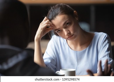 Bored unhappy girlfriend listening to African American boyfriend in cafe, bad first impression and date concept, multiracial couple having sitting at table, talking, having problem in relationships - Shutterstock ID 1395298574