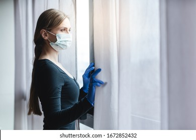 Bored Woman In Corona Quarantine Looking Out Of Window To The Street 