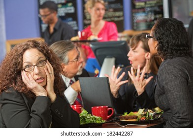 Bored Woman With Coworkers At Lunch Break