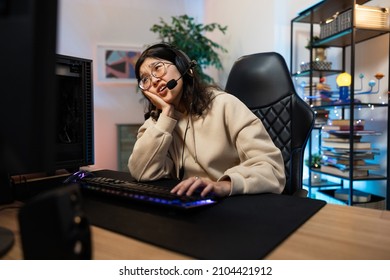 Bored Woman Loses Game On Computer She Survives Whines Disappointed, She Supports Herself With Hand Under Chin Looking Disappointedly At Monitor Gamer Girl Spends Time In Room Lit By Led Lights