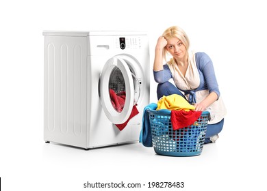 Bored Woman Sitting By A Washing Machine And Doing Laundry Isolated On White Background