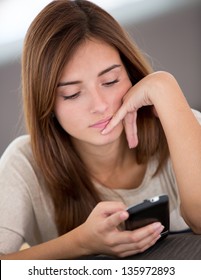 Bored Woman Texting On Her Mobile Phone