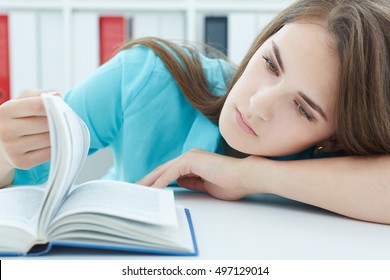 Bored woman trying make herself study at workplace suffering because of exam deadline concept. Education and self development.