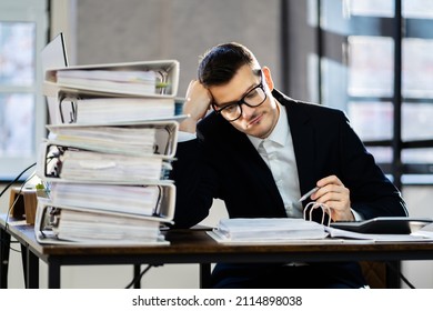 Bored Workaholic Businessman At Office Desk With Stress - Shutterstock ID 2114898038