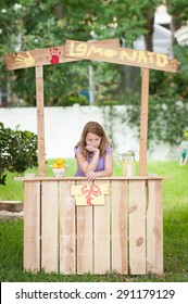 Bored Young Girl With No Customers At Her Lemonade Stand