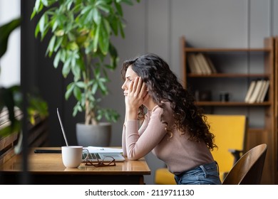 Bored Young Girl Student Tired Of Learning Sit In Library Looking At Laptop Sad And Unhappy. Lazy Apathetic Female Freelance Writer Frustrated About Task Computer Work Feeling Uninterested Demotivated