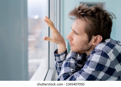 Bored Young Man Feeling Sad And Standing In Front Of The Mirror 