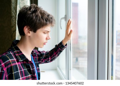 Bored Young Man Feeling Sad And Standing In Front Of The Mirror 