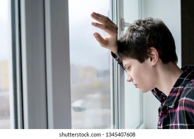 Bored Young Man Feeling Sad And Standing In Front Of The Mirror 