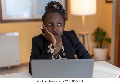 Bored young woman tired of working or studying at home looking at a laptop, lazy atitude daydreaming thinking gazing wishing - Shutterstock ID 2135916089