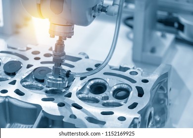 The boring machine make the hole at the cylinder head in the light blue scene.Automotive part manufacturing process .