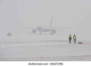 BORISPOL, KIEV, UKRAINE - FEBRUARY, 5, 2015:  Staff At The Borispol Airport Observed The Aircraft Landing During A Snowfall