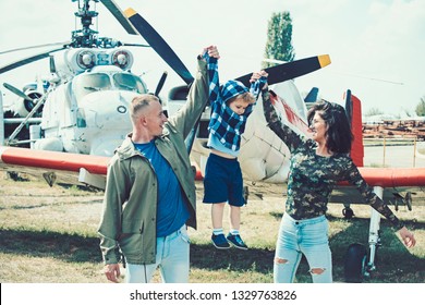 Born To Be Adventurers. Family On Vacation Trip. Couple With Boy Child At Helicopter. Helicopter Tour And Travel. Air Travel. Enjoying Travelling Fun. Family Vacation. Travelling By Air.