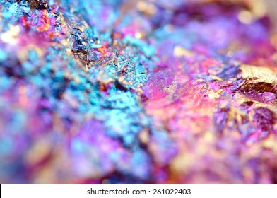 Bornite, Cu5FeS4 that crystallizes in the orthorhombic system (pseudo-cubic). Macro. Background for successful Your projects. Stone surface background. Colored crystal background.