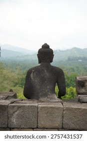 Borobudur, Central Java, Indonesia - July 12, 2024: Majestic stone stupas of the world’s largest Buddhist temple at sunrise. Ancient UNESCO heritage site showcasing intricate reliefs and statues.