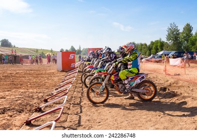 BOROVICHI, RUSSIA - JULY 12, 2014: Motocrossers In The Starting Line Waiting For Race To Start