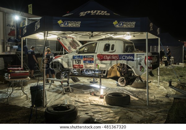 BORTALA, CHINA-JULY 16, 2016: Mechanics cater to sports\
cars and trucks day and night during the  Silk Way rally\
Moscow-Beijing Dakar series \
