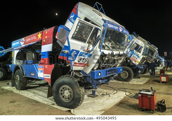 BORTALA, CHINA-JULY 16, 2016: Mechanics cater to sports\
cars and trucks day and night during the Silk Way rally\
Moscow-Beijing Dakar series\
