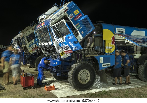 BORTALA, CHINA-JULY 16, 2016: Mechanics cater to\
sports cars and trucks day and night during the Silk Way rally\
Moscow-Beijing Dakar\
series