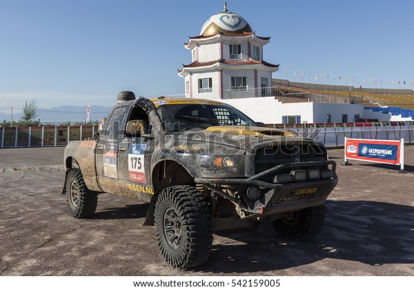 BORTALA, CHINA-JULY 16, 2016: Mechanics cater to\
sports cars and trucks day and night during the Silk Way rally\
Moscow-Beijing Dakar\
series