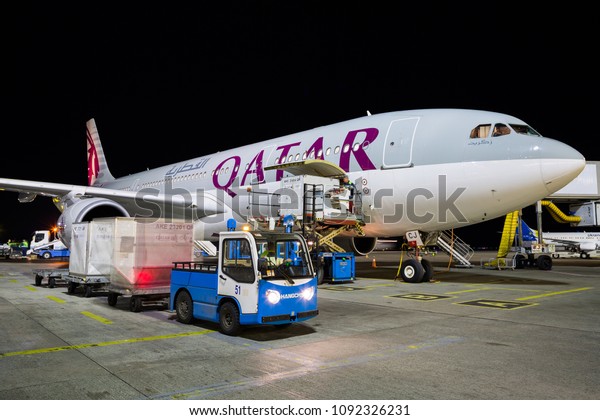 BORYSPIL, UKRAINE - APRIL 26, 2018:\
Qatar Airways Airbus A330. Qatar Airways aircraft. Airport\
overview. Handling vehicles. Aircraft cargo loading,\
unloading.