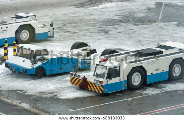 BORYSPIL,\
UKRAINE - FEBRUARY 08, 2015: Service tarmac trucks parked in winter\
Boryspil International Airport, the countrys largest airport\
serving over 8 million passengers per\
year.
