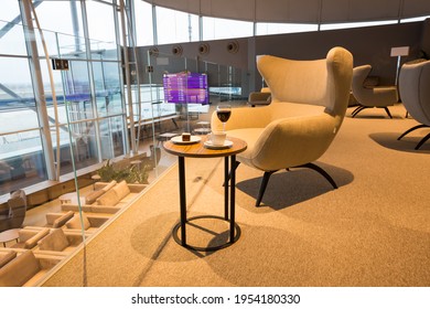 Boryspil, Ukraine - FEBRUARY 15, 2021: Airport Business Class Lounge. International Airport Interior. Airport VIP Lounge. Modern Airport. Business Lounge Food. Glass Of Wine.