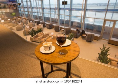 Boryspil, Ukraine - FEBRUARY 15, 2021: Airport Business Class Lounge. International Airport Interior. Airport VIP Lounge. Modern Airport. Business Lounge Food. Glass Of Wine.