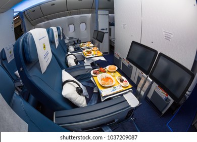 Boryspil, Ukraine - FEBRUARY 22, 2018: Ukraine International Airlines Boeing 777 Premium Economy Class Seats. Onboard Dining. Sky Catering. Inflight Entertainment IFE Screens. Economy Class Cabin.   