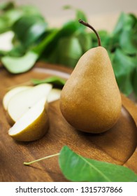 Bosc Pear And Sliced Pear On Wooden Tray With Leaves, Pear Season