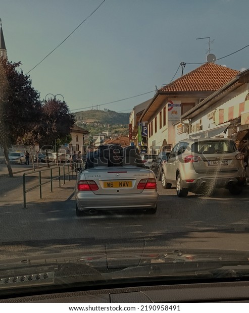 Bosnia and Hercegovina, Sarajevo,\
17.7.2022. Overloaded private Mercedes cabriolet vehicle carrying\
to many heavy luggage. British registration\
plates.