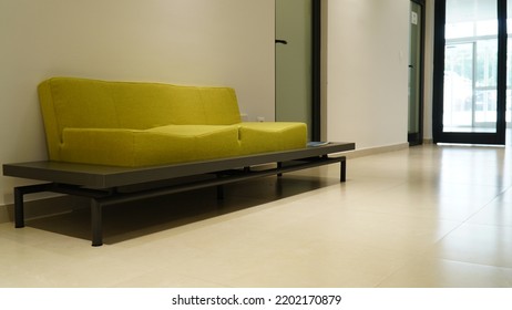 BOSNIA AND HERCEGOVINA, SARAJEVO 2022: Lightened Business Building Lobby With A Door And Green Sofa For Clients Waiting For  Visit. Modern Sofa For Modern Designed Spaces