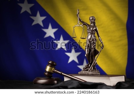 Bosnia and Herzegovina flag with statue of lady justice, constitution and judge hammer on black drapery. Concept of judgement and punishment