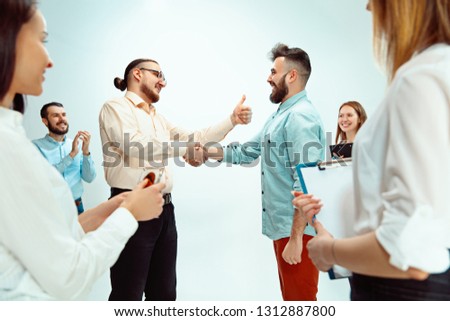 Boss approving and congratulating young successful employee of the company for his successes and good work. National Employee Appreciation Day, businesswoman, businessman, business, success, admire