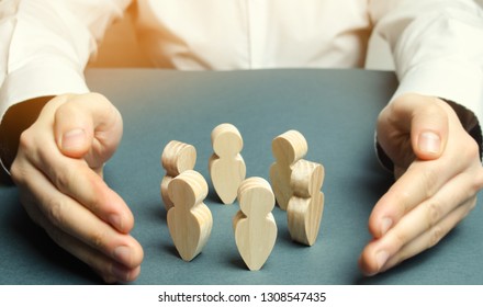 Boss defending his team with a gesture of protection. Life insurance. Customer care, care for employees. Security and safety in a business team. Human resources. A responsibility. Social protection - Shutterstock ID 1308547435