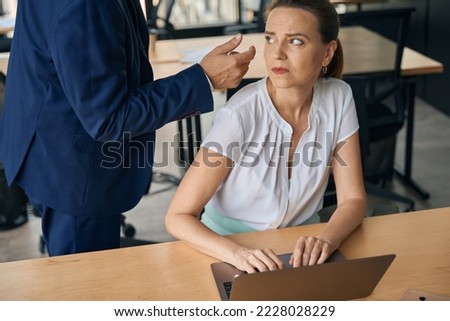Boss flirting with woman while she is feeling angry
