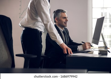 Boss and his young assistant discussing actual working tasks. Business concept - Shutterstock ID 1686979942