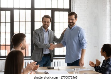 Boss Shake Hands Introduces New Employee To Members During Briefing In Board Room, Staff Clap Hands Encourage Newcomer Welcoming Express Regard. Praise And Appreciation, Best Worker Of Month Concept