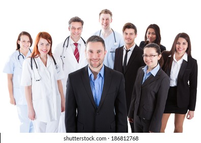 Boss standing on front of his team of doctors and managers